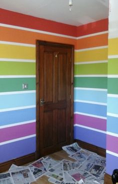 an image of a room that has been painted with rainbows and stripes on it