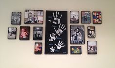 a wall with many pictures and hand prints on it