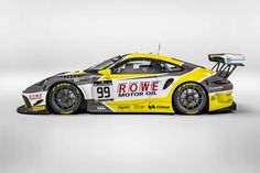 a yellow and white race car with the number 99 rowe motor oil on it