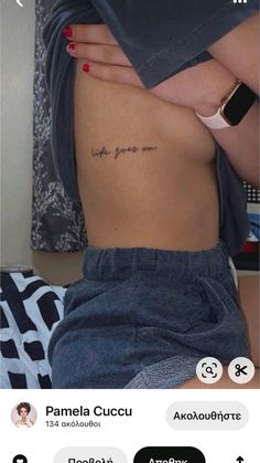 the back of a woman's stomach with an inscription on her left side, which reads