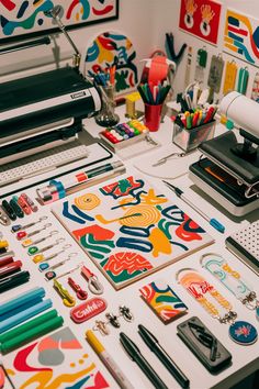 the desk is covered with art supplies such as markers, pens and crayons