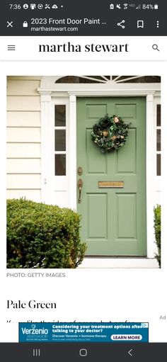 a green door with a wreath hanging on it's side and the words martha stewart above