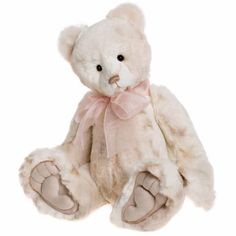 a white teddy bear with a pink bow on it's head and paws, sitting in front of a white background