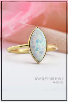 Let your style shine bright with this chic opal ring. Marquise Opal Ring, Delicate Opal Ring, Dainty Wedding Opal Ring, Bridesmaid Gift Ring, Marquise Gold 14K Opal Ring, 18k Solid Gold Ring #womensjewelry #opalrings #chicjewelry #weddingring #engagementring Opal Ring With Bezel Setting, 14k Gold Opal Ring Hallmarked, Gold Opal Birthstone Wedding Ring, Opal Ring With Bezel Setting Gift, Opal Moonstone Ring For Anniversary, Marquise Opal Jewelry Gift, Marquise Opal Jewelry As A Gift, Marquise Opal Jewelry For Gift, Opal Marquise Jewelry For Gifts