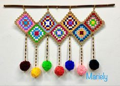 the beaded wall hangings are decorated with colorful beads and tassels on wooden sticks