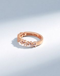 a rose gold ring with three diamonds on it