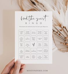 someone is holding up a printable game for the guests to play on their wedding day