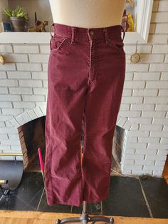 "Here is an amazing pair of vintage corduroy pants by Levi's. 84% cotton, 16% polyester, and made in the USA. Wonderful maroon color with slightly darker stitching. Zipper and button at front, with two pockets on the front and back. Perfectly worn, soft and comfy. These pants are in excellent condition with years of life left! Here are the measurements taken laying flat: Waist: 16\" Width of one leg (mid thigh) 9\" Length: 42\" Inseam: 30\"" Burgundy Cotton Jeans For Fall, Burgundy Cotton Wide Leg Pants, Levi's Math Club Corduroy, Fitted Red Corduroy Bottoms, Vintage Straight Leg Corduroy Pants, Vintage Straight Leg Corduroy Bottoms, Burgundy Straight Leg Cotton Bottoms, Burgundy Straight Leg Cotton Jeans, Vintage Corduroy Pants