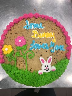 there is a cake that has been decorated with flowers and an bunny on the side