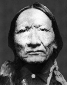 an old black and white photo of a native american man with wrinkles on his face