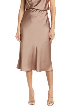 Elevate your wardrobe with this pull-on bias satin midi skirt for elegant, feminine style. 31" length (size S) Elasticized waist Pull-on style Satin construction 97% polyester, 3% spandex Machine wash cold, line dry Made in USA Model’s stats for sizing: 5’10” height, 34” bust, 27” waist, 35” hips. Model is wearing size S. Elegant Feminine Style, Elegant Feminine, Satin Midi Skirt, Concert Looks, Sweaters And Leggings, Casual Streetwear, Comfortable Dress, Dress Romper, Jeans Dress