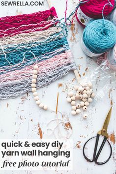 yarn, beads and scissors sitting on top of a table