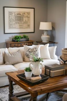 a living room filled with lots of furniture and decor on top of a wooden table