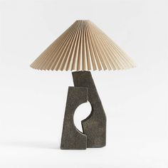 a table lamp made out of folded paper and a wooden base with a light shade on top