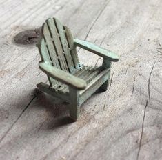 a miniature chair sitting on top of a wooden floor