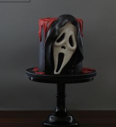 there is a cake that has been decorated to look like a scream mask on it