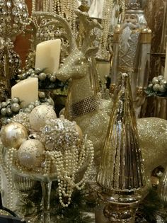 a table topped with lots of gold and white ornaments