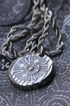 I have done several pendants including this one. Here seen is a super rare Niobium/Zirconium damascus pendant with a 2.5 VS1 Natural Canadian diamond set in 14k white gold. The edge of the pendant is Titanium /Zirconium damsacus with all stainless laser welded jump rings and chain. Unique Etched Pendant Jewelry, Silver Carved Round Necklace, Silver Carved Round Pendant Necklace, Unique Etched Round Pendant Necklace, Luxury Etched Pendant Necklaces, Luxury Etched Pendant Jewelry, Cross Pendant Diamond, Laguna Niguel, Pendant Diamond