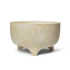 a white bowl sitting on top of a wooden stand