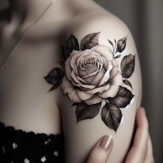 a woman's arm with a rose tattoo on it and leaves around the arm