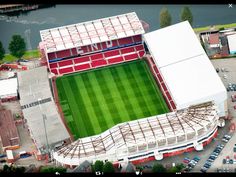 an aerial view of a soccer stadium with cars parked in the parking lot