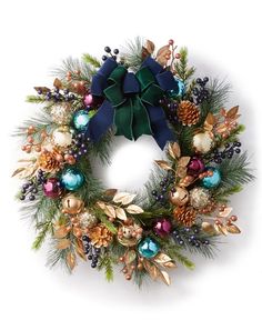 a christmas wreath with pine cones, berries and other holiday decorations on white background photo