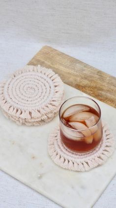 a drink sitting on top of a table next to two coasters