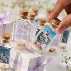 a person is placing their wedding date in a bottle