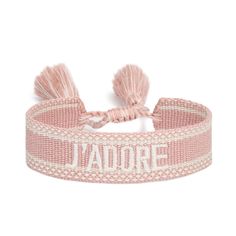 a pink and white bracelet with the word jadore on it