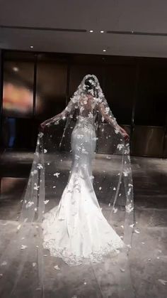 a woman in a wedding dress is covered with water