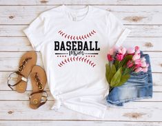 a t - shirt with the words baseball mom on it next to flowers and sandals