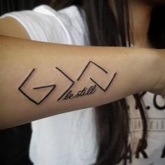 a woman with a tattoo on her arm that says restall in cursive writing