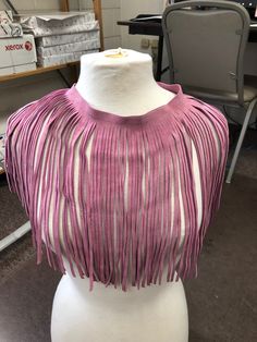 a mannequin with pink and white fringes on it