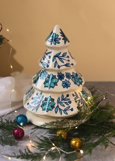 a ceramic christmas tree sitting on top of a table