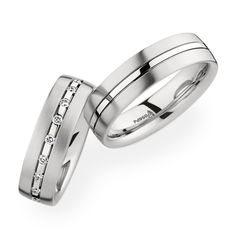 two white gold wedding bands with channeled diamonds set in the center, on top of each other