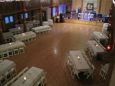 an empty dance floor with tables and chairs set up for a formal function in the center