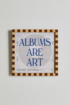 an art piece with the words albums are art in blue and brown stripes on it