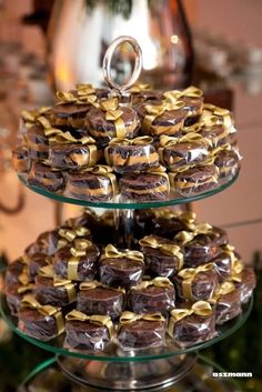 three tiered trays filled with chocolate covered donuts