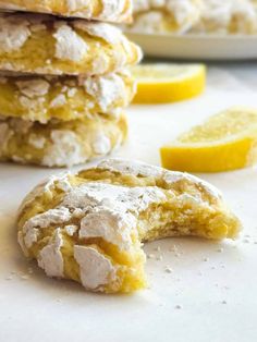 lemon cookies with powdered sugar are stacked on top of each other