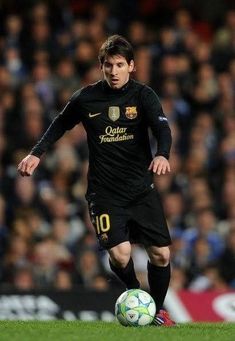 a soccer player is running with the ball in his hand while people watch from the stands