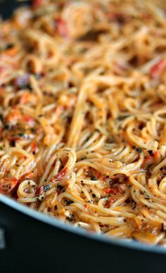 a pan filled with pasta and sauce on top of a table