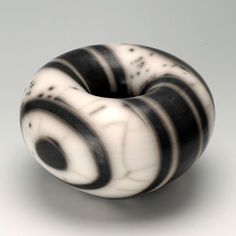 a black and white striped donut sitting on top of a table