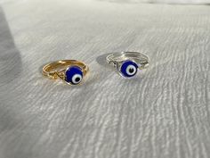 (items are shipped between 1-2 days) Evil Eye Ring, Wire Wrapped Ring, Wire Wrapped Evil Eye Ring *A gold or silver wire wrapped Evil eye ring  These evil eye rings are perfect on their own or paired with other rings. They also make great gifts for friends and loved ones as well as buying a matching pair for you and your bestie! I recommend avoiding water and keeping it stored away when not being worn to maintain its quality. OTHER EVIL EYE JEWELRY PEICES 🧿 Evil Eye Heart and Freshwater Pearl Necklace  https://www.etsy.com/listing/1396346610/heart-evil-eye-fresh-water-pearl Evil Eye Bead Choker in Multiple Colors  https://www.etsy.com/listing/1348736599/evil-eye-choker-evil-eye-bead-choker White Seed Bead Evil Eye Choker https://www.etsy.com/listing/1406471828/evil-eye-necklace-evil-eye-c Gift Wire Wrapped Adjustable Stackable Rings, Adjustable Wire Wrapped Stackable Rings As Gift, Wire Wrapped Open Midi Rings As Gift, Gold Wire Wrapped Spiritual Ring, Gift Stackable Wire Wrapped Adjustable Rings, Spiritual Gold Wire Wrapped Rings, Wire Wrapped Midi Rings As Gift, Wire Wrapped Midi Rings For Gift, Gift Wire Wrapped Midi Rings