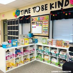 a classroom with lots of books and toys on the shelves in front of the desk