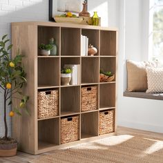 a wooden shelf with baskets and books on it