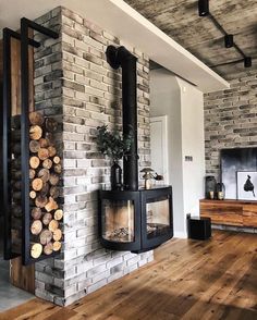 a living room filled with furniture and a fire place next to a wall mounted tv