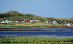 the houses are on the hill above the water