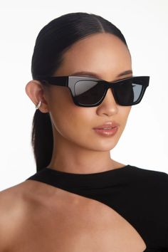 a woman wearing sunglasses and black dress