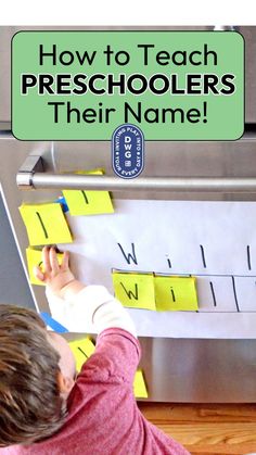 a young boy is writing on the back of a refrigerator with sticky notes attached to it