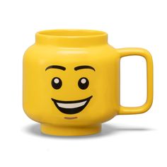 a yellow mug with a smiley face on it